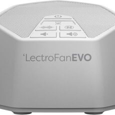 White LectroFan Evo device on a bedside table, with simple control buttons visible on its top surface.