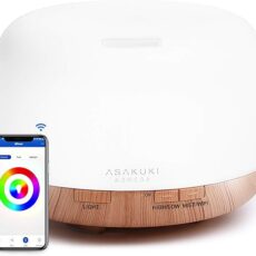 ASAKUKI Smart Wi-Fi Essential Oil Diffuser on a bedside table, emitting a visible mist with soft ambient lighting.