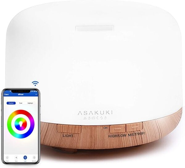 ASAKUKI Smart Wi-Fi Essential Oil Diffuser on a bedside table, emitting a visible mist with soft ambient lighting.