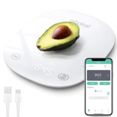 White arboleaf digital kitchen scale weighing half an avocado, displayed alongside a smartphone showing the connected app